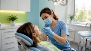 Dental hygienist professionally cleaning patient's teeth