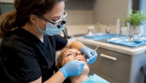 Close-up dental scaling at gum line